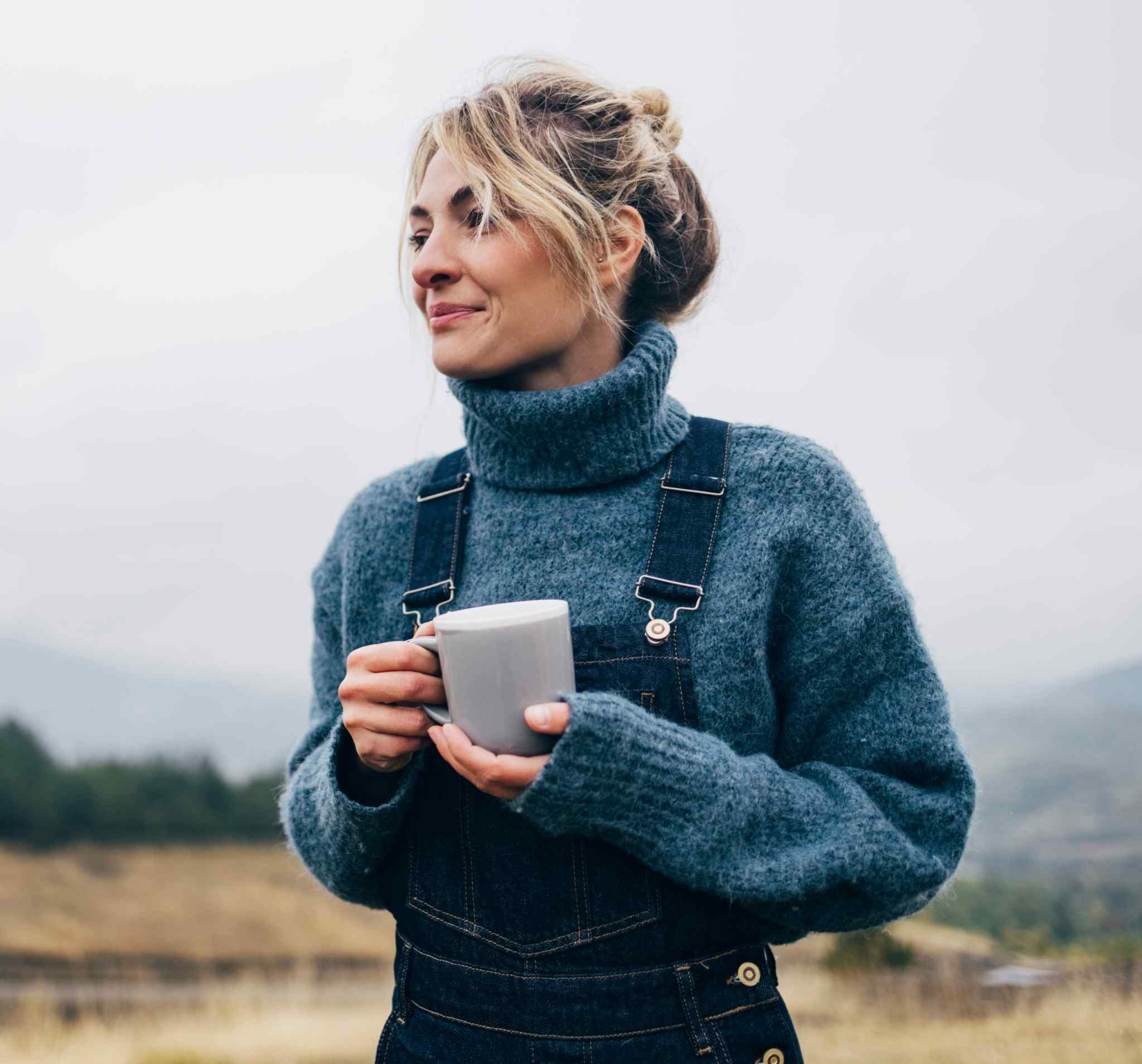 Beautiful Woman Drinking Tea in Nature